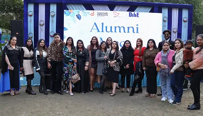 A batch of alumni posing together for a photo